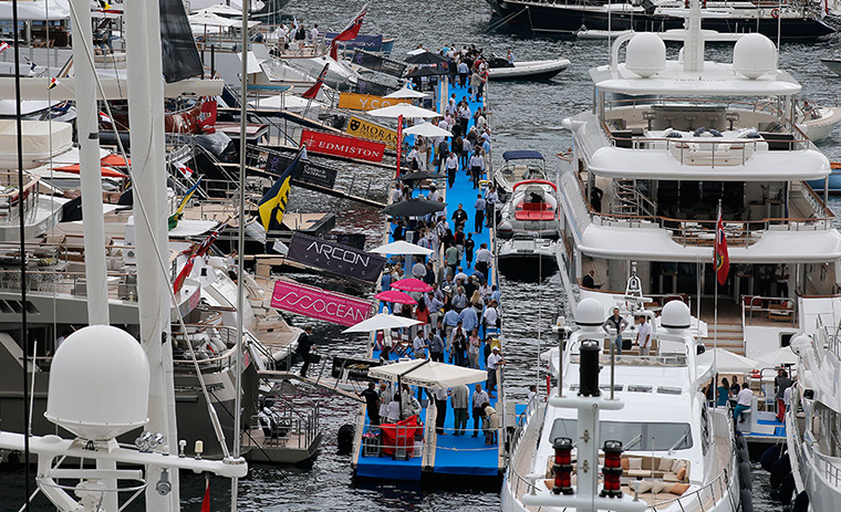 Yachts: Visitors walk between yachts