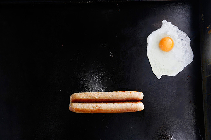 Roadside snacks: An egg and a sausage fry on a grill in May's snack van along the A22 near C