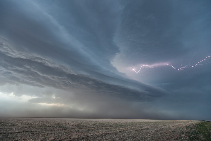 Storm cloud formations: Horizontal lightning shoots from the centre of a supercell thunderstorm nea