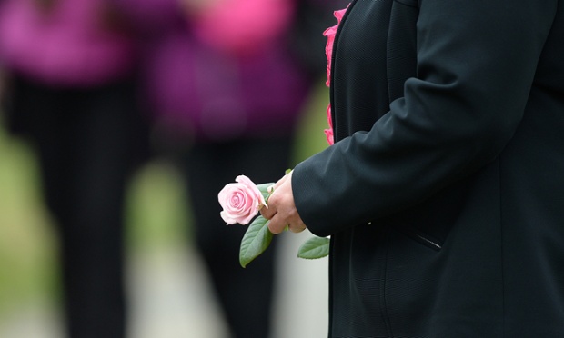 A mourner carries a pink rose as she arrives for the funeral service of murdered schoolgirl April Jones at St Peter's church, Machynlleth in Wales. Photographing a funeral can be very intrusive so focusing on this gesture is poignantly effective.