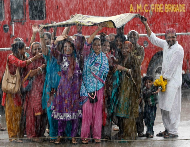 This picture needs no explanation for being in today's top ten other than it's purely delightlful. Relatives of pilgrims wave in the rain as they say farewell to family members who are leaving Ahmedabad in India for Mecca for the annual Haj pilgrimage.