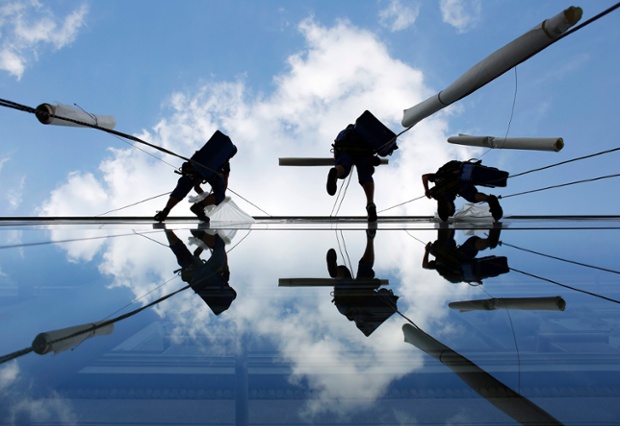 At first glance they look like dancers in the sky but actually they're window cleaners replacing banners on  Jugoslovensko Dramsko theatre in Belgrade, Serbia.