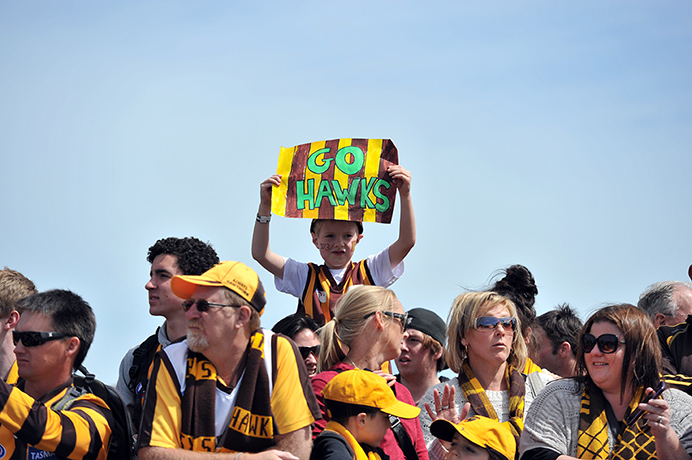 AFL Parade: A young Hawthorn fan holds up a sign