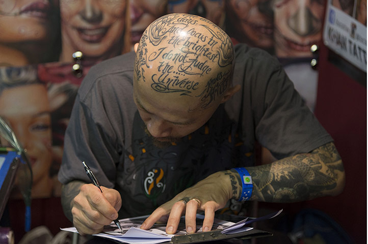 Tattoo Convention: A tattoo artist prepares a design