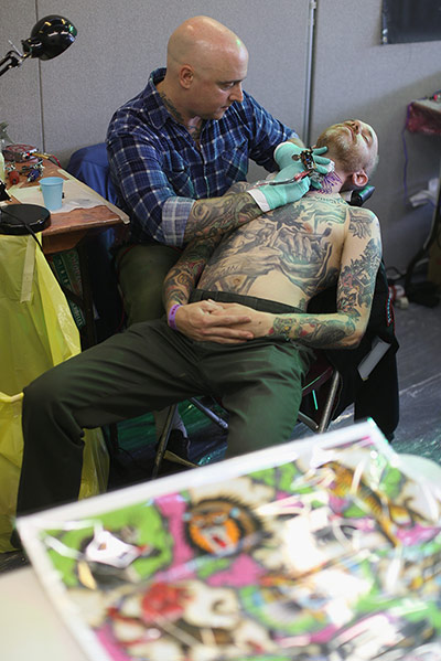 tatts out: A tattoo enthusiast has his neck tattooed