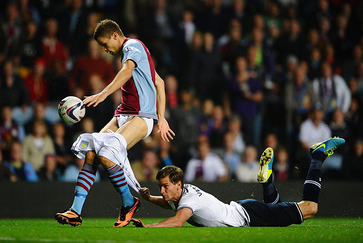 20 Photos: Jan Vertonghen of Spurs hangs on to the shorts of Nicklas Helenius of Aston Villa