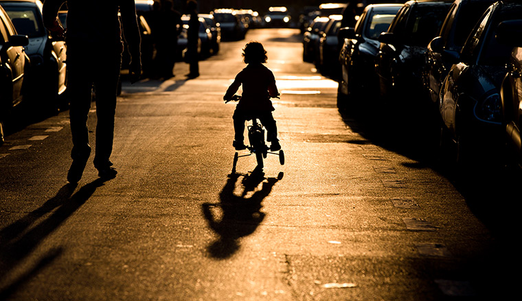 Weekend in pictures: Bucharest, Romania: A child rides a bicycle silhouetted by the setting sun