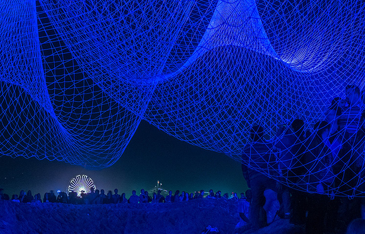 Glow Santa Monica: Visitors explore The Space Between Us by artist Janet Echelman 