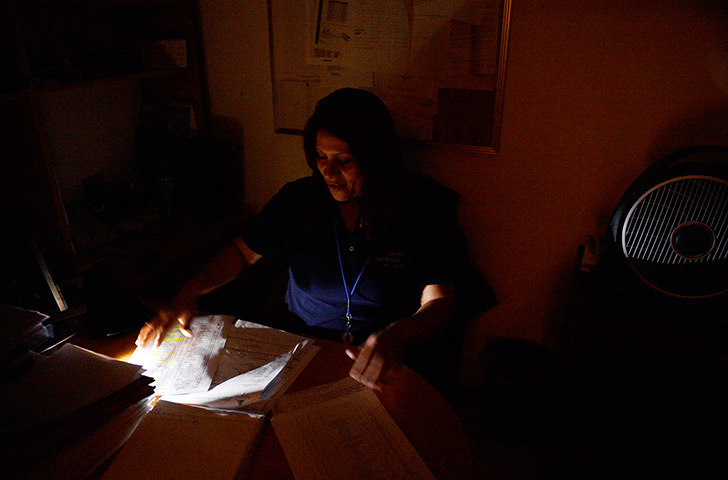 Venezuela blackout: A woman works during a blackout