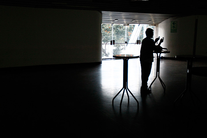 Venezuela blackout: A man uses mobile phones as he waits for the power to return