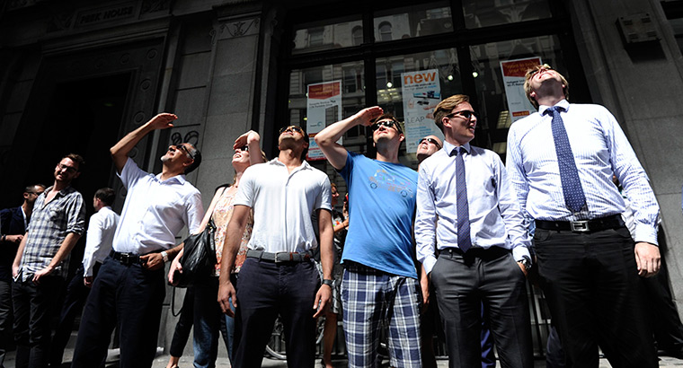 Walkie scorchie: People look up at the Walkie Talkie, as it reflects sunlight