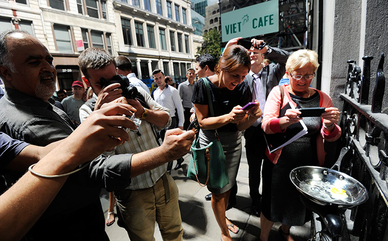 Walkie scorchie: A man holds a frying pan to cook an egg in the beam of light 