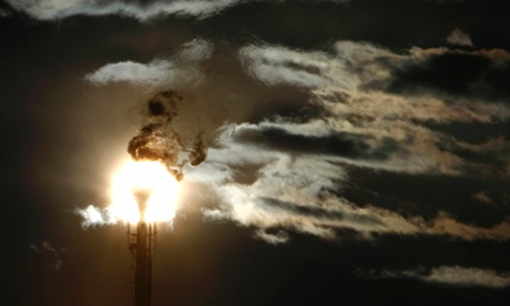A flare stack emitting fire is silhouetted against the sun at an oil refinery in Melbourne June 24, 2009. A senator crucial to Australia's plans for carbon trading said on Wednesday he did not believe climate change was real, delivering what could be a fatal blow to government plans to slash industrial gas emissions. REUTERS/Mick Tsikas (AUSTRALIA POLITICS ENERGY ENVIRONMENT BUSINESS IMAGES OF THE DAY) :rel:d:bm:GF2E56O0NFZ01