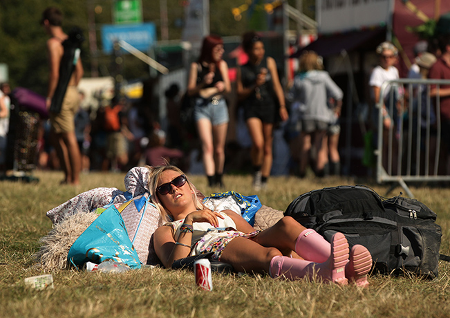 Bestival day 1: A festivalgoer relaxes in the sun