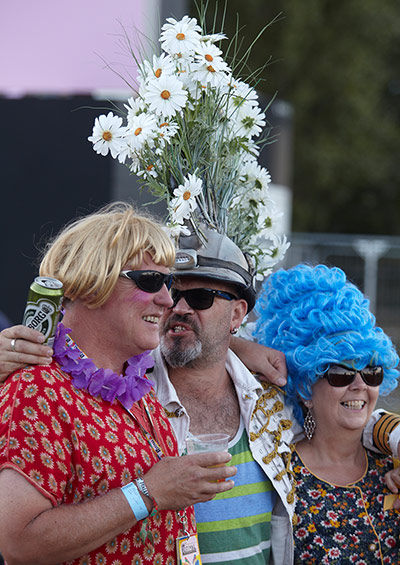 Bestival 2013: A reveller with an impressive flower mohican enjoys the festival