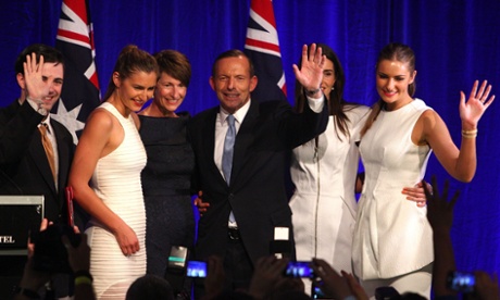 Serial protester Fregmonto Stokes jumps up on stage with the Abbott family at the Liberal party celebration in Sydney.