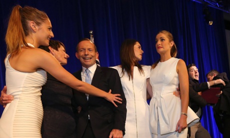 Fregmonto Stokes, far right, is taken off stage by security next to newly elected prime Mpminister Tony Abbott and his family. Photograph: Pool/Getty Images