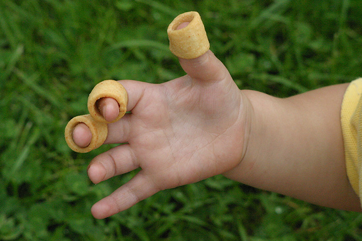 British brand: Hula Hoops crisps on a child's fingers