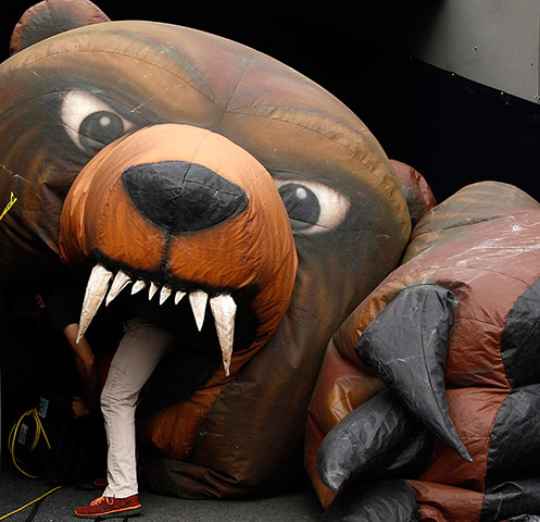 NFL Week One Gallery: A worker deflates a Chicago Bears inflatable mascot