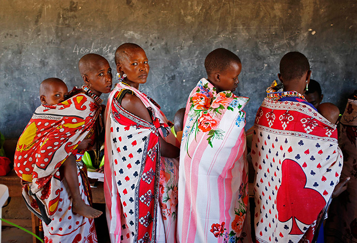 Goran Tomasevic: Masai women wait to cast ballot papers in a polling station during the pres