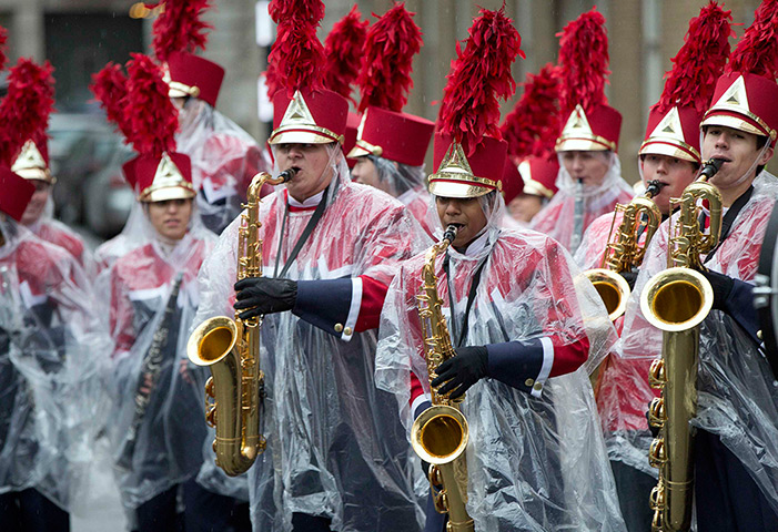 Photo highlights: A marching band wear rain ponchos as they perform at the 28th annual New Ye