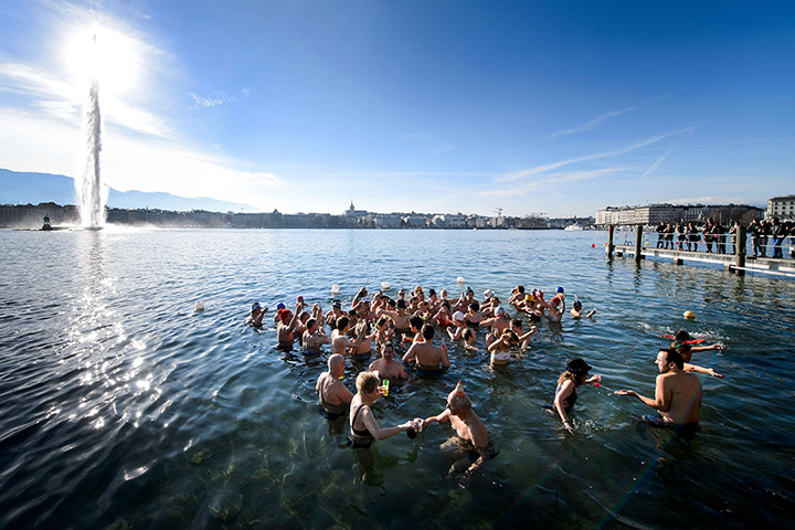 Photo highlights: People hold glasses of champagne as they celebrate in Lake Geneva, Switzerl
