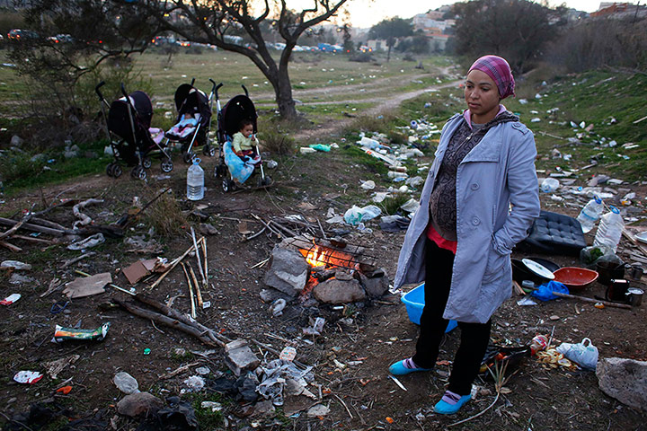 Melilla: A 24-year-old woman who is pregnant and homeless stands near a fire 