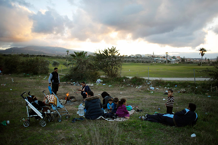 Melilla: Syrian refugees pass the time outside a refugee centre