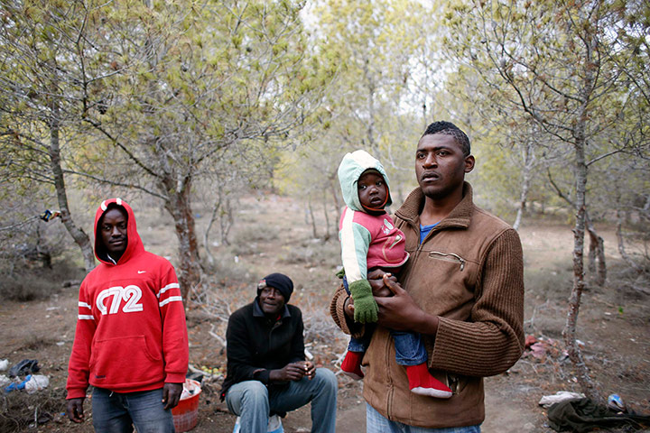 Melilla: African migrants stand in a clandestine campsite 