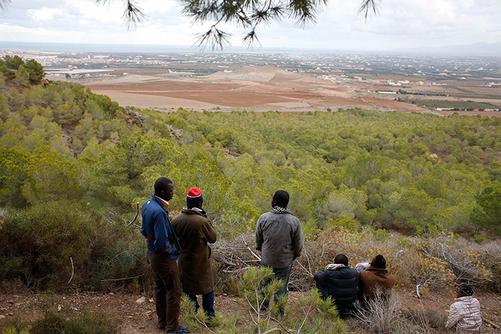 Melilla: African migrants watch for police near a clandestine campsite
