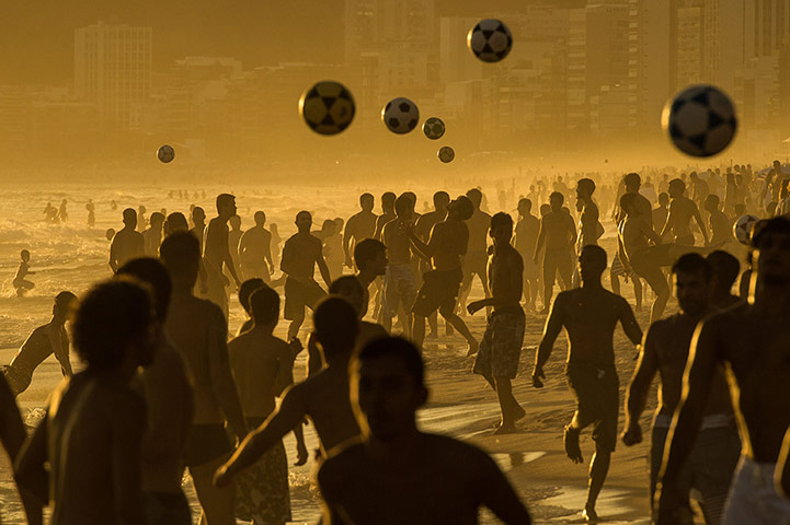 20 Photos: People play football at sunset on Ipanema Beach in Rio de Janeiro