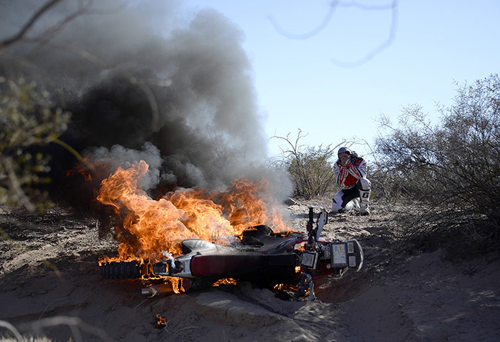 20 Photos: Paulo Goncalves watches his motorbike burn at the Dakar Rally