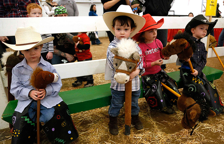 Weekend in pictures: Colorado, USA: Children wait to compete in the stick horse rodeo at the Nat
