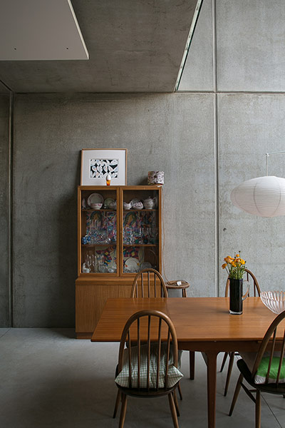 Homes - Concrete house: dining area of house with concrete wall