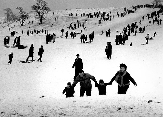 Looking-Back-Lyme-Park: Sledgers climb the slopes