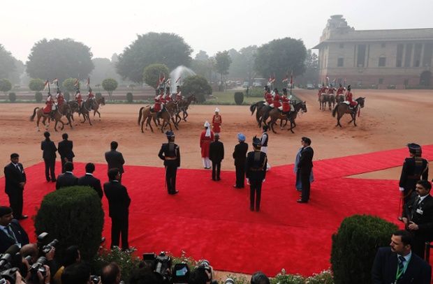 Plenty of red carpet is in evidence as India's President Pranab Mukherjee and Prime Minister Manmohan Singh (wearing the blue turban) wait to receive South Korean President Park Geun-Hye at the forecourt of India's presidential palace in New Delhi.