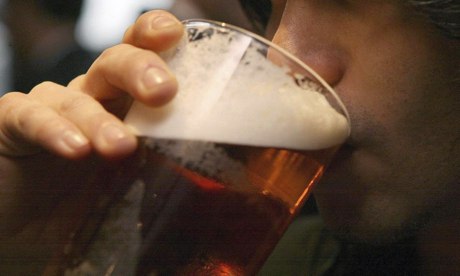 A man drinking a pint of beer