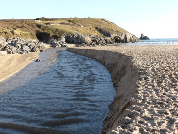 'The thousands of tonnes of sand redistributed from nearby dunes to steepen the beach - here cut though by usually trickling stream from Bosherston Ponds.' The view from Broadhaven, Pembrokeshire