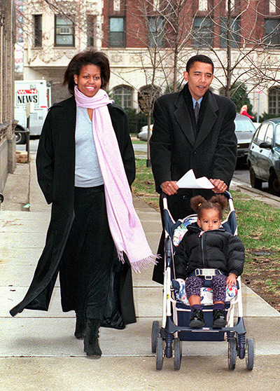 Michelle Obama at 50: Senator Barack Obama walks with his wife, Michelle, and daughter, Malia, ag