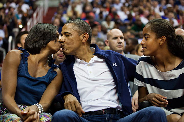 Michelle Obama at 50: 16 July, 2012: Malia watches her parents kiss for the 