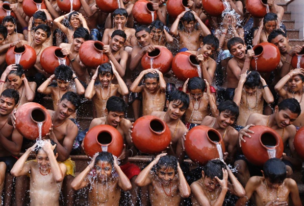 Students pour water on each other as they take a holy bath on the occasion of Magh Purnima in the western Indian city of Ahmedabad.