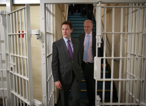 Behind bars: Deputy Prime Minister Nick Clegg and Justice Minister Chris Grayling visit the Cookham Wood Young Offenders Institution in Rochester, Kent.