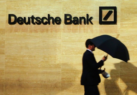 A man walks past Deutsche Bank offices in London in this December 5, 2013 file photo.