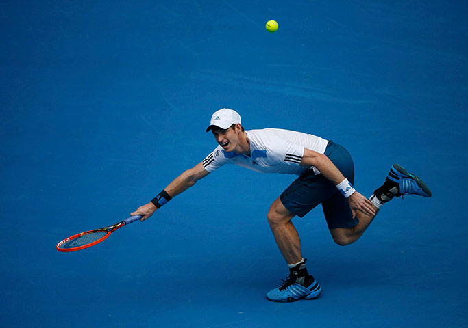 aussie open day 8: Andy Murray of Britain hits a return to Stephane Robert of France