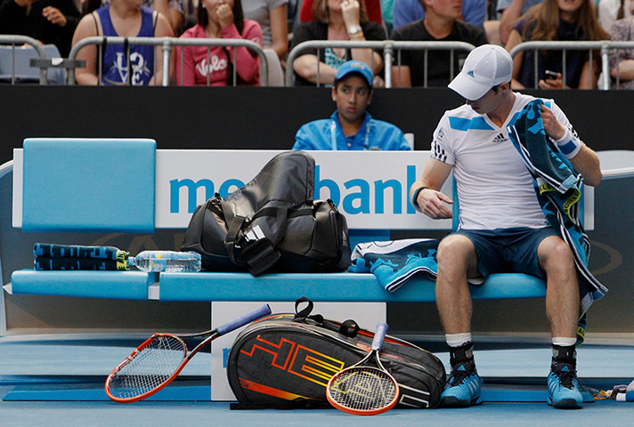 aussie open day 8: Andy Murray of Britain looks at the racquet 