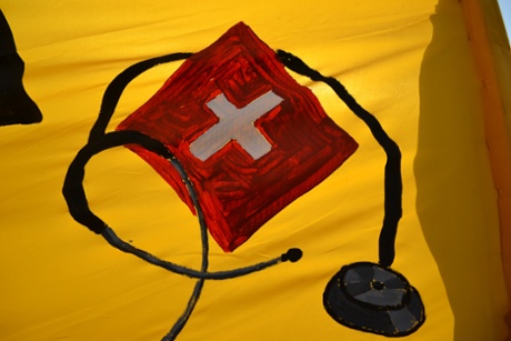 Athens, Greece. 20th January 2014 -- A drawing of a stethoscope is seen on a banner -- A demonstration was organised in the Neos Kosmos region of Athens against the dissolution of public healthcare in Greece .