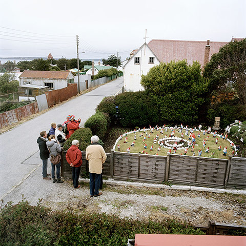 Big Picture - Empire: German tourists look at gnomes in a garden