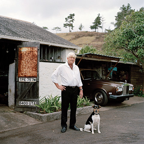 Big Picture - Empire: man with white hair stands next to dog outside house