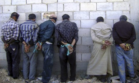 Detained Syrian men, blindfolded and handcuffed, in Qusair, near Homs