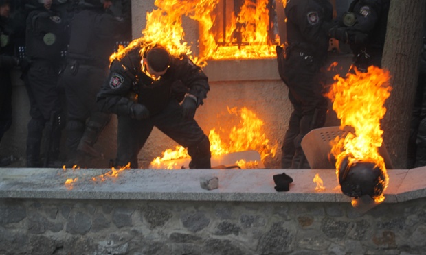 Members of the Ukrainian riot police are caught in the line of gasoline bombs hurled by anti-government protestors during the clashes in Kiev